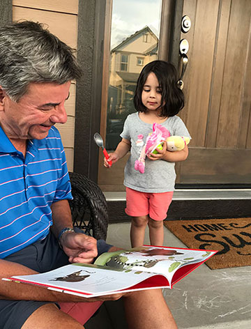 Grandpa and Priya reading Grumpy Monkey