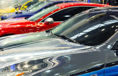 Close up of different cars in a row. Source: Adobe Stock