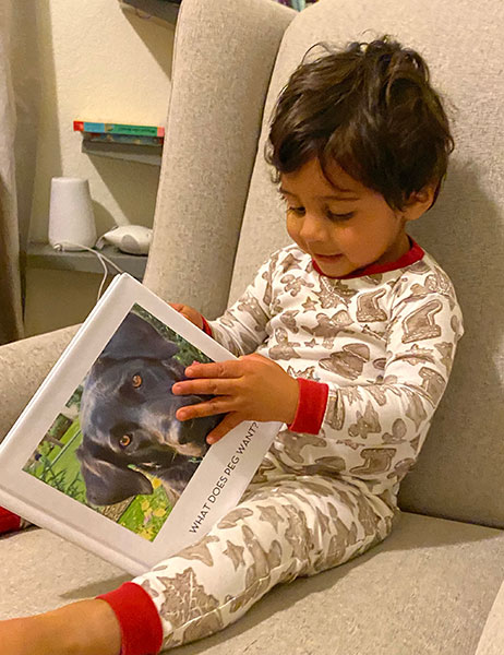 Nikhil reads Connie’s creation, a book featuring Reading Team dog Peg