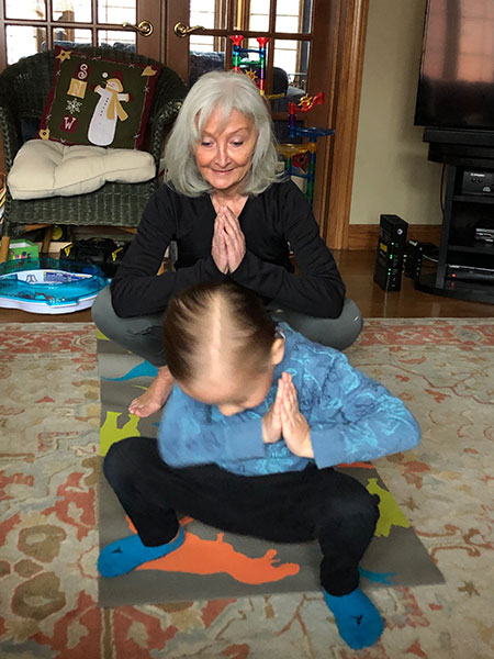 Ann and Teddy practice yoga