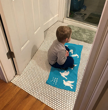 boy sitting on peace blanket