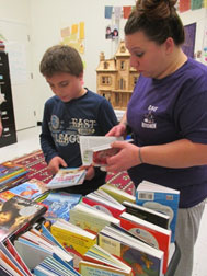 mother selecting books with her son