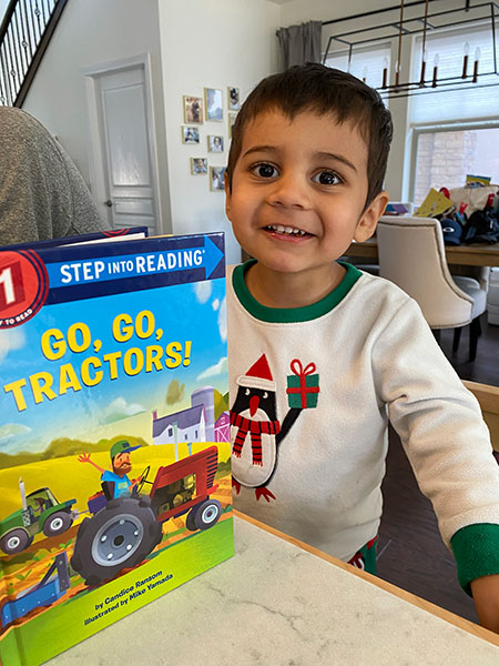 Nikhil reading Go, Go Tractors!