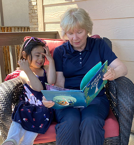 Priya and Grandma reading Birds of a Feather